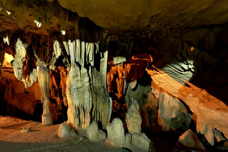 Explore the majestic stalactites and rock formations inside this natural cave.