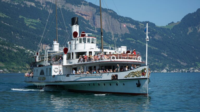 Explore a vintage steamboat on Lake Lucerne with breathtaking Swiss mountain views.