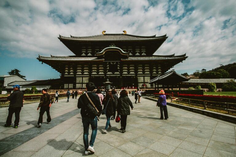 Tourists explore the historic Todai-ji Temple, a famous landmark in Nara, Japan.