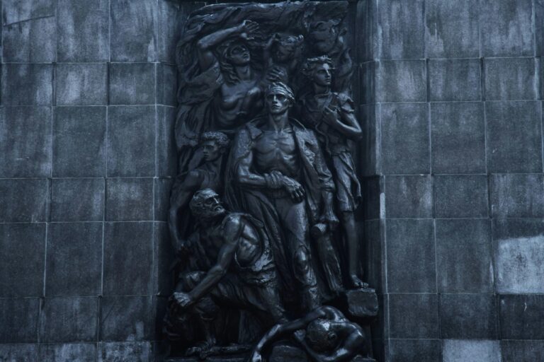 Detailed view of a sculptural monument in Warsaw, showcasing dramatic artistic expression.