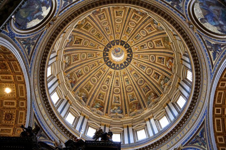 Intricate interior view of St. Peter's Basilica dome, showcasing ornate religious art and architecture in Vatican City.