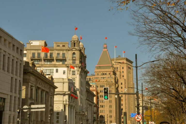 Iconic view of Shanghai's Bund showcasing historical architecture under a clear blue sky.