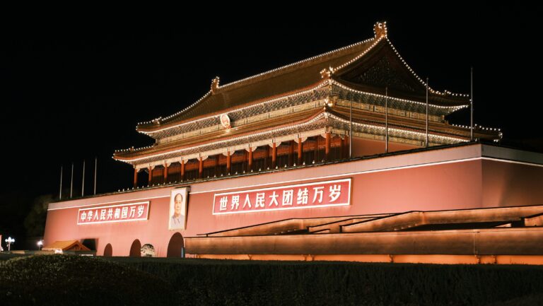 Stunning night view of Tiananmen Gate in Beijing, featuring illuminated traditional architecture.