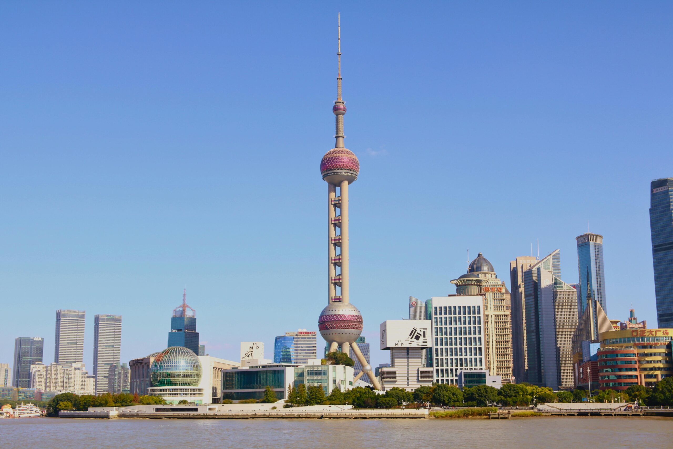 Capture of Shanghai's iconic skyline featuring the Oriental Pearl Tower during a clear day.