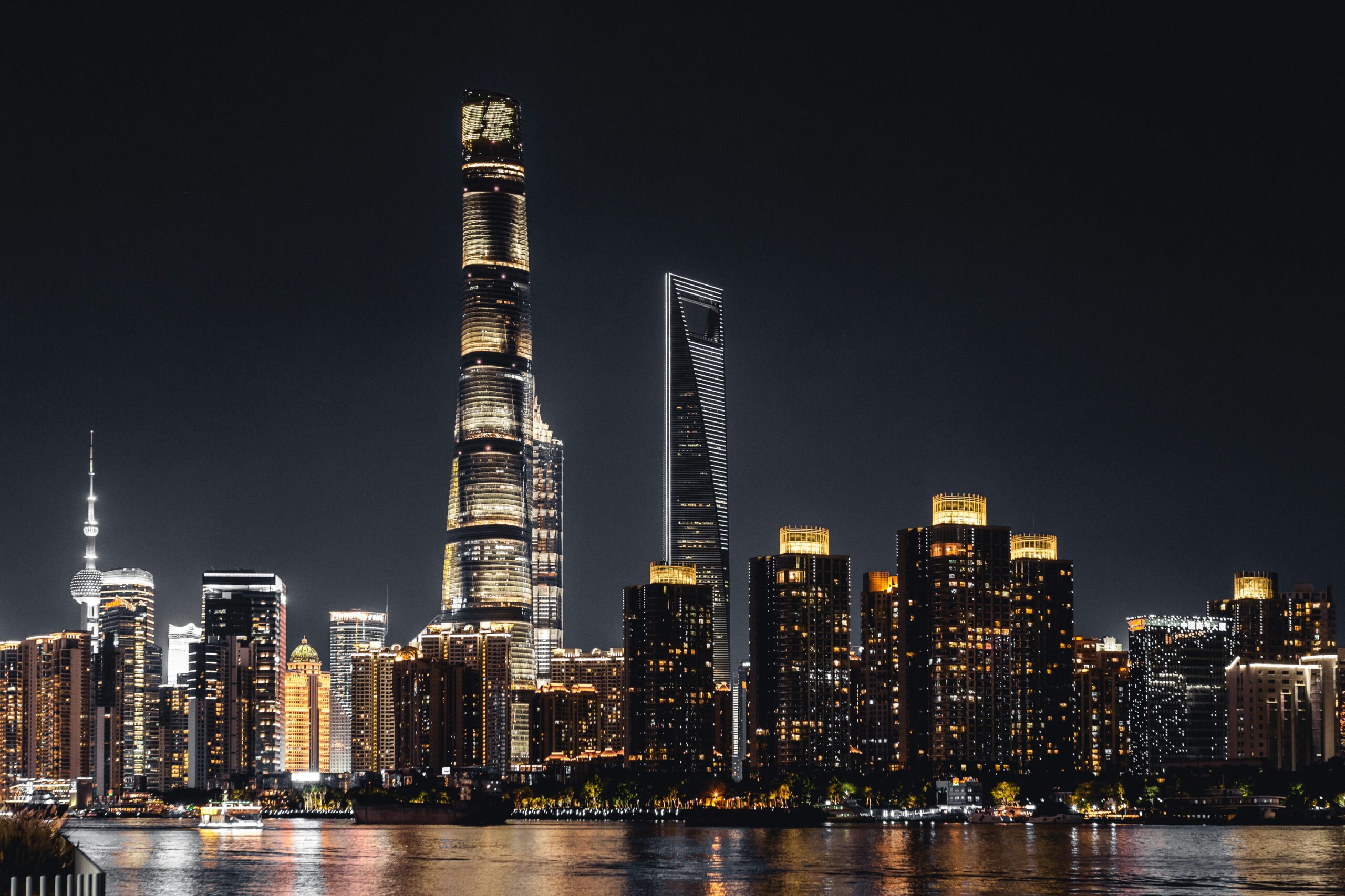 Shanghai skyline illuminated against the night sky featuring iconic skyscrapers.
